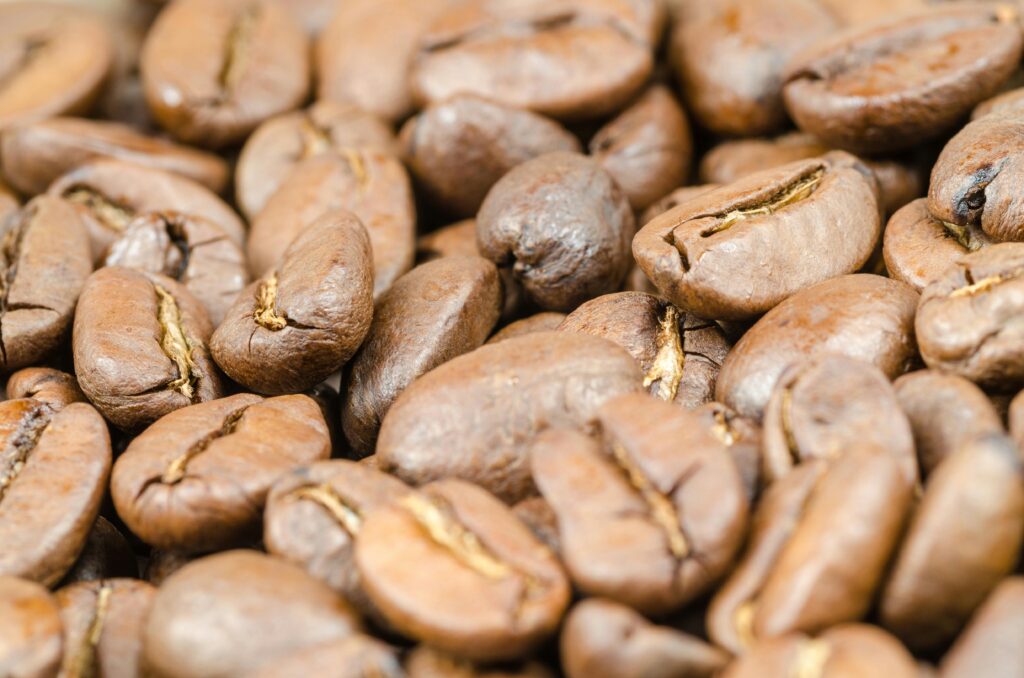 Detailed close-up of aromatic roasted coffee beans showcasing rich brown hues and texture.